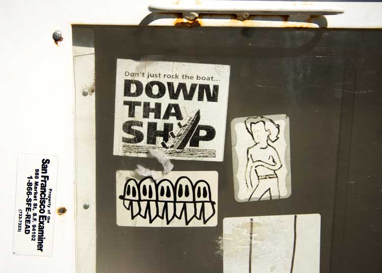 A sidewalk newspaper box in Oakland.